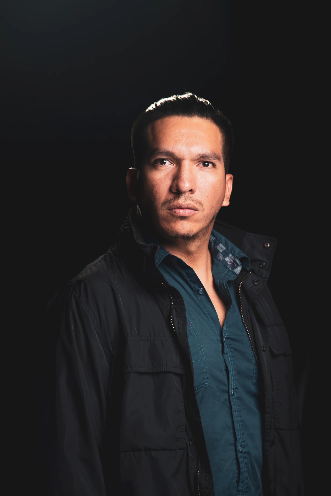 Francisco Yazbek, wearing a dark jacket over a deep-blue shirt, looking directly into the camera