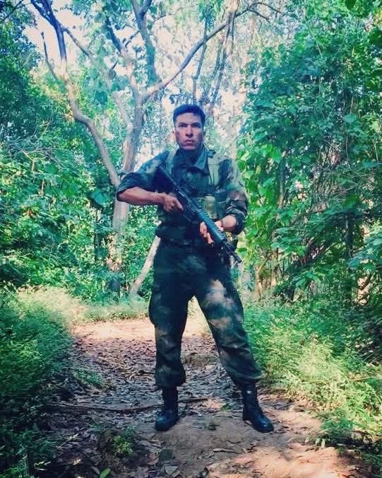 Francisco Yazbek in military costume standing on a forest path for Luciérnagas en El Mozote