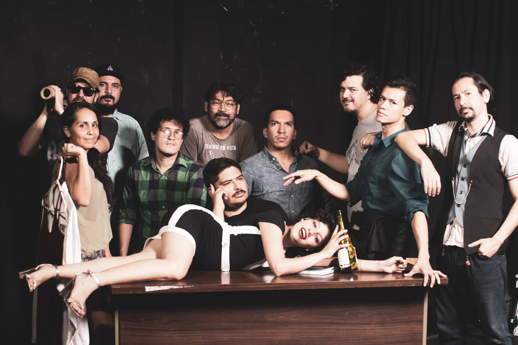 The theatre company gathered around a table in costume